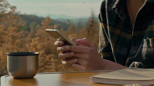 Woman Using Mobile Phone in Natural Environment