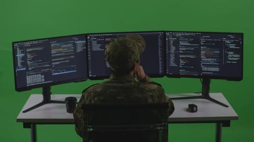 Asian Man Soldier Developer Thinking While Write Code With Multiple Screens In Green Screen