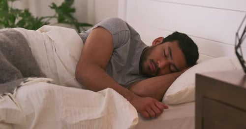 Man Sleeping Peacefully in Bed at Home