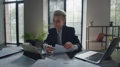 Professional Woman on Video Call in Modern Office