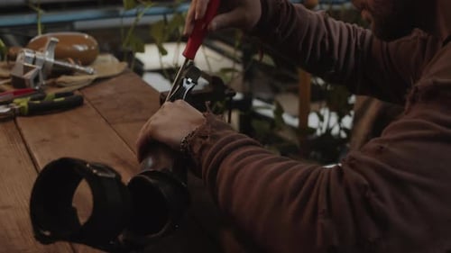Man Working with Tools at a Workbench