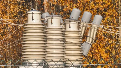 Power lines with sun rays on blue sky. High voltage substation. Electricity crisis in the world. Gre