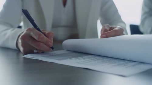 Businesswoman signing contract close up on hands writing in office