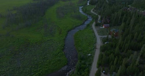 Tilting drone shot of a stream in field in the rocky mountains in Grand Lake, Colorado