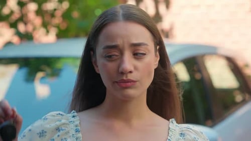 Worried Woman Holding Car Keys, Expressing Confusion