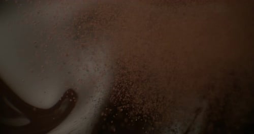 hazelnuts fall in chocolate fondant and liquid milk in slow motion
