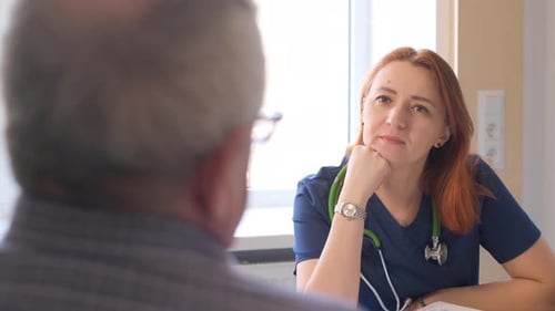Female Doctor Speaking to Patient at Medical Office