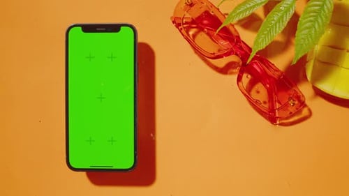 Phone with Green Screen Chroma Key on Orange Background Composition of Smartphone Cell Phone
