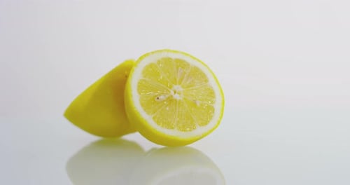 Macro close up of fresh juicy wet lemon fruit on a wooden restaurant kitchen table
