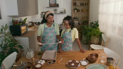 Mother and Child Baking Cookies Together at Home