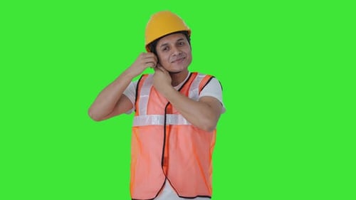 Happy Indian construction worker wearing the helmet Green screen