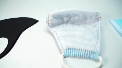 Close up different style of face mask on the table. Slow movement shot. Concept health world organiz