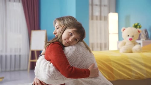 Loving Mother and Daughter Embracing in Home