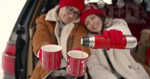 Family Sitting in a Car Among Winter Forest