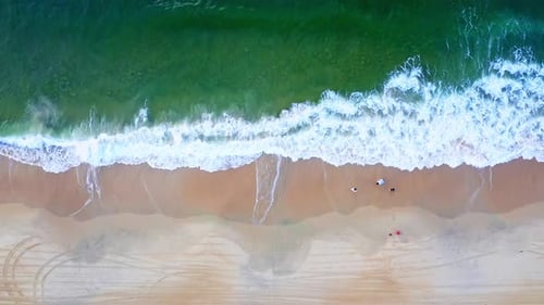 Aerial Top view of a transparent blue sea with beautiful waves at sunny day in summer. air of ocean