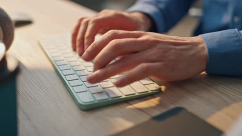 Unrecognizable businessman typing on computer keyboard at home office in slow motion