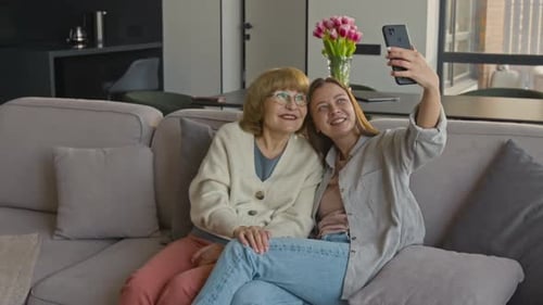 Woman and Senior Woman Take a Smartphone Selfie
