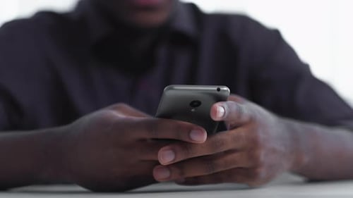 Close Up of Hands Using a Mobile Phone
