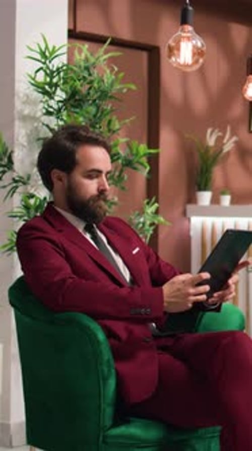 Vertical Video Business Associate Reads Files on Tablet