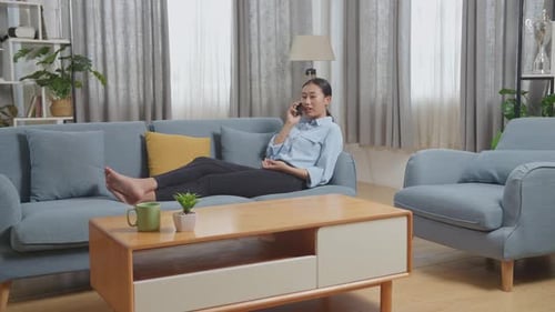Woman Relaxing at Home and Talking on Phone