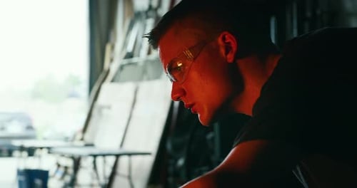 Sweaty Man Working With Metal in Workshop