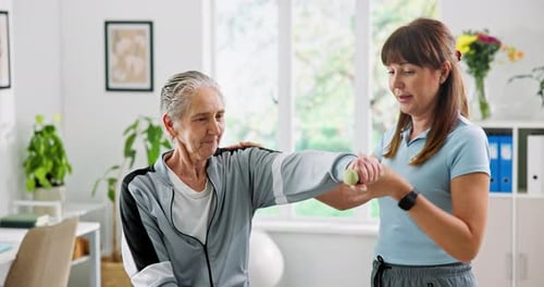 Medical, dumbbells and physical therapist with senior woman in clinic with recovery rehabilitation