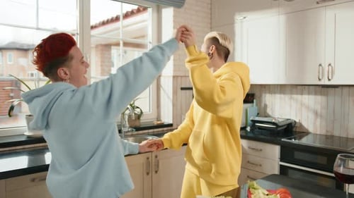 Two Friends Dancing in a Bright Kitchen