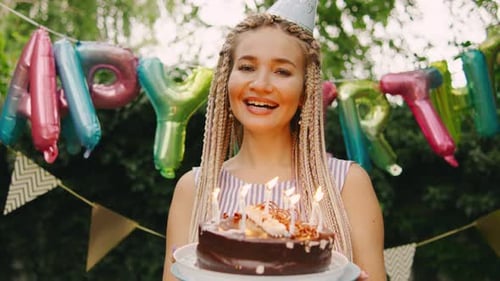 Woman with Birthday Cake Outdoors