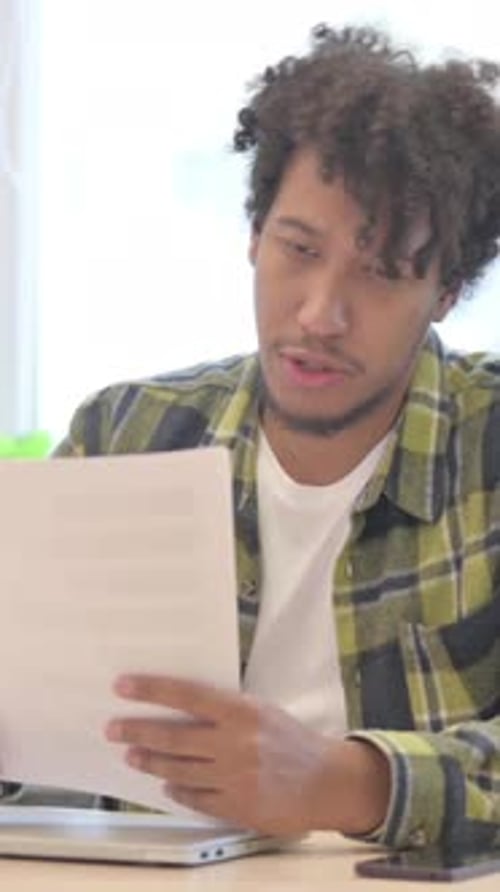 African Man Reading Documents in Office, Doing Paperwork, Vertical Video