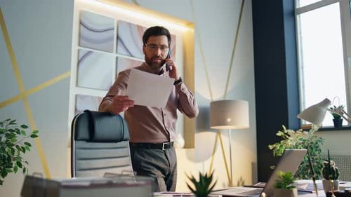 Bearded Boss Speaking Telephone Standing Modern Office Leaning on Chair. Confident Successful