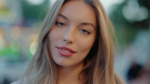 CloseUp Portrait of a Young Woman with Long Blonde Hair in Urban Setting