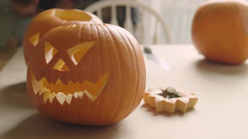 Carved halloween pumpkins displayed on a table celebrating the autumn season