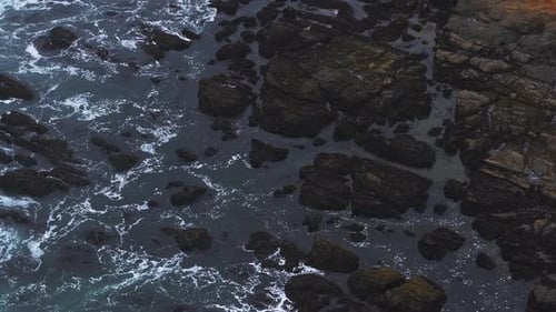 Luftaufnahme der Wellen des Pazifischen Ozeans, die auf die Klippenfelsen treffen