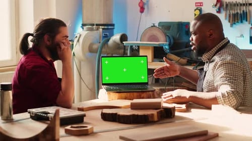 Craftsperson and Coworker Designing Custom 3D Furniture on Chroma Key Notebook