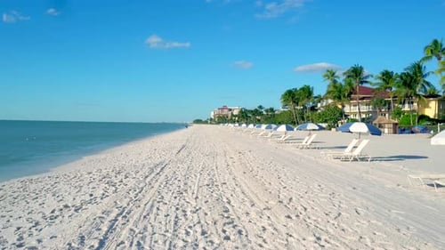 Aerial drone view of colorful umbrellas on a naples Florida beach resort