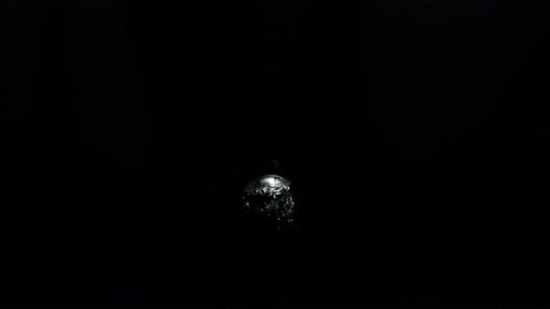 Submerge Collection: Small bubbles slowly moving upwards from the bottom on a black background