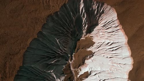 Aerial of wide gorge with rocky cliffs from both sides of small canyon. Clip. Stone slopes