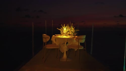 Table for romantic dinner at night served on the outdoor terrace of restaurant