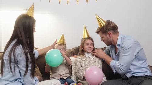 Family Celebrates Birthday Together on the Couch