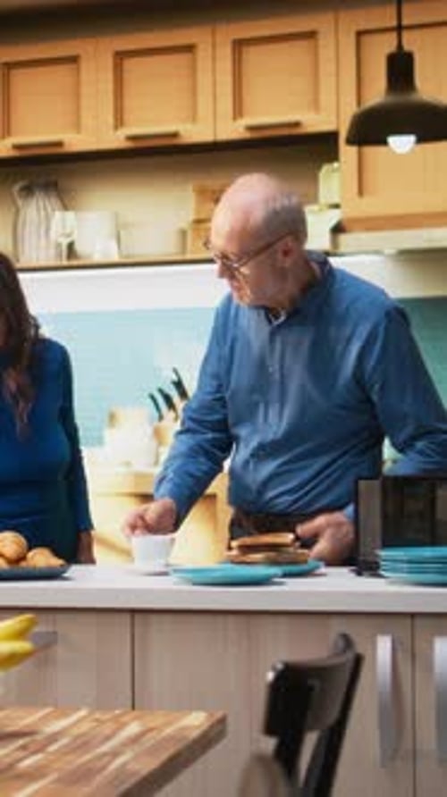 Loving Senior Couple Dancing Together in Kitchen