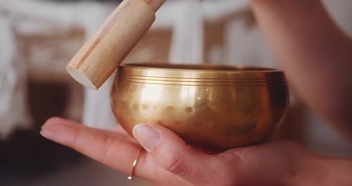 Woman Meditating Holding Tibetan Singing Bowl. - close up