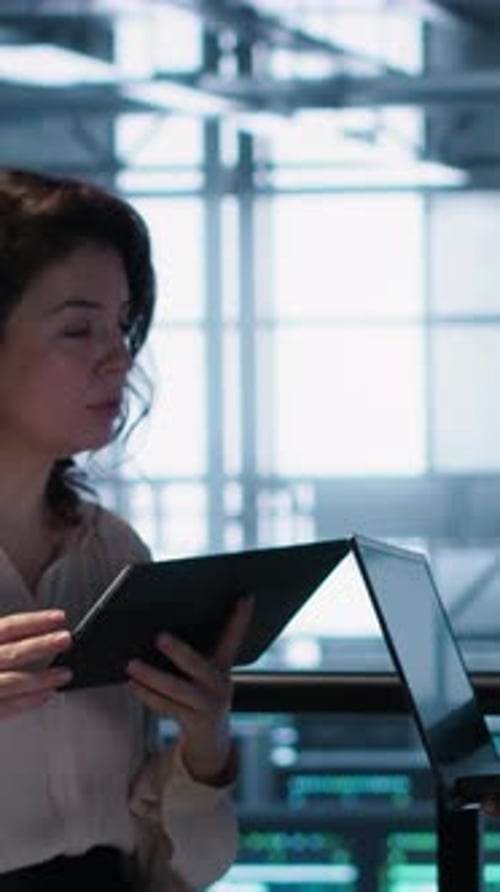 Vertical Video Data Scientists Performing Equipment Vulnerability Scans in Server Farm