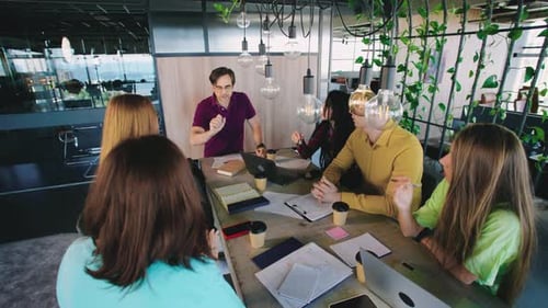 Engaged Team Discussing Ideas in Modern Office