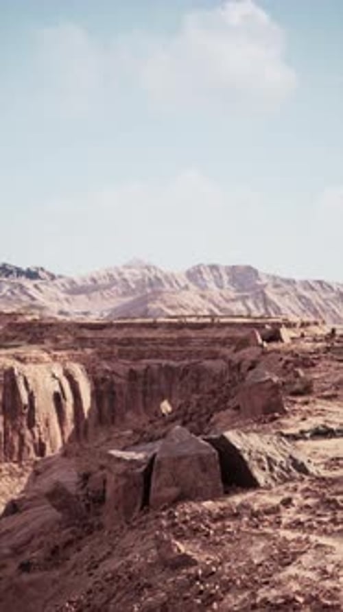 Barren Desert Landscape With Distant Mountains