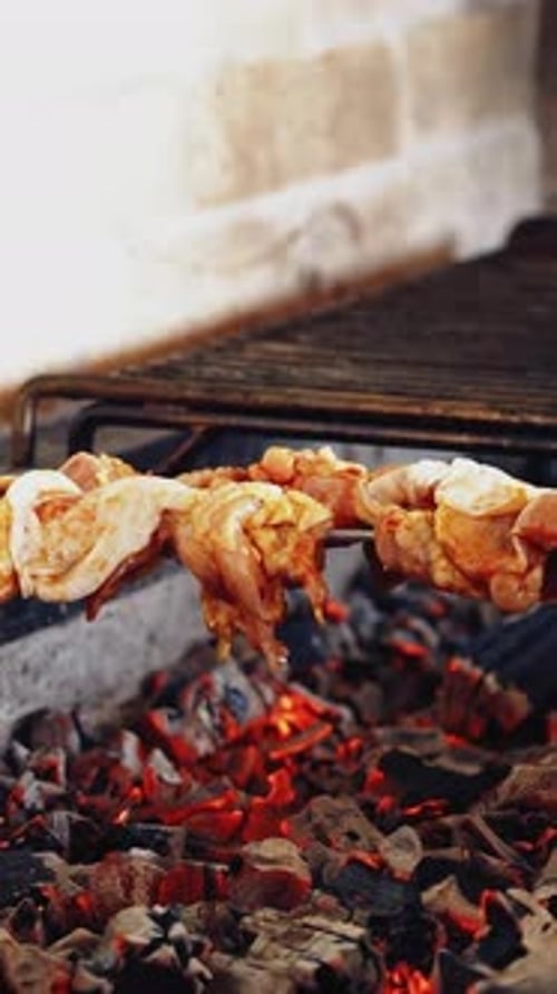 Meat Skewers Cooking on Fiery Grill