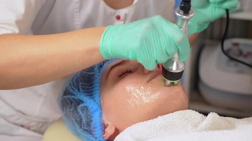 Woman Receiving Facial Treatment in Medical Office