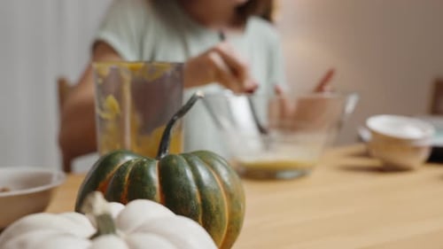 Ingredients for Pumpkin Cookies, Woman Kneading Dough, with Small Pumpkins of Various Colors .