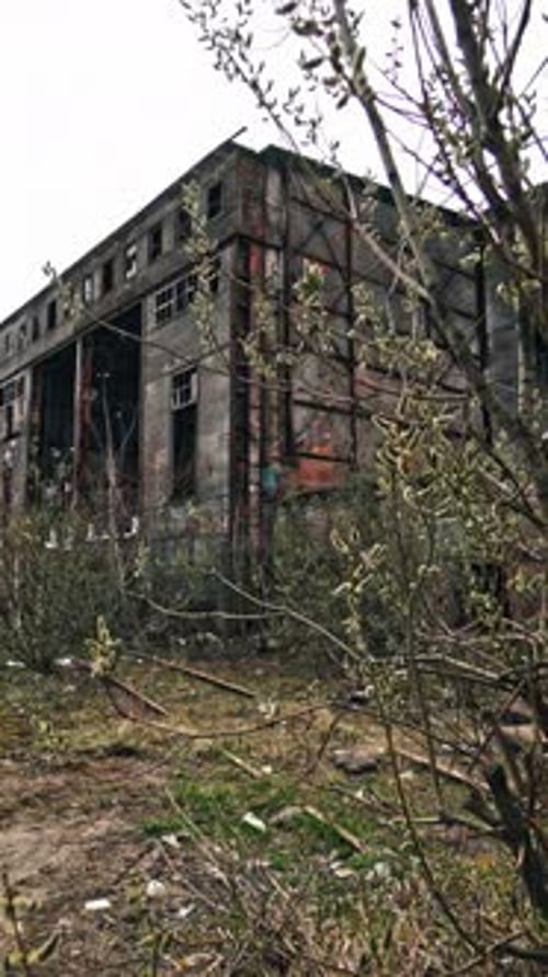 Abandoned factory. Ruins of a very heavily polluted industrial factory. Vertical video