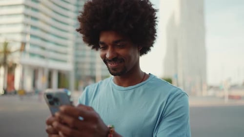 Young Adult Using Phone in Urban Environment