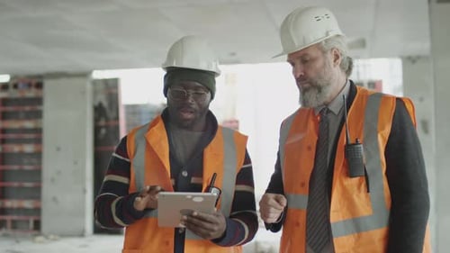 Foreman and Worker Discussing Issues at Construction Site